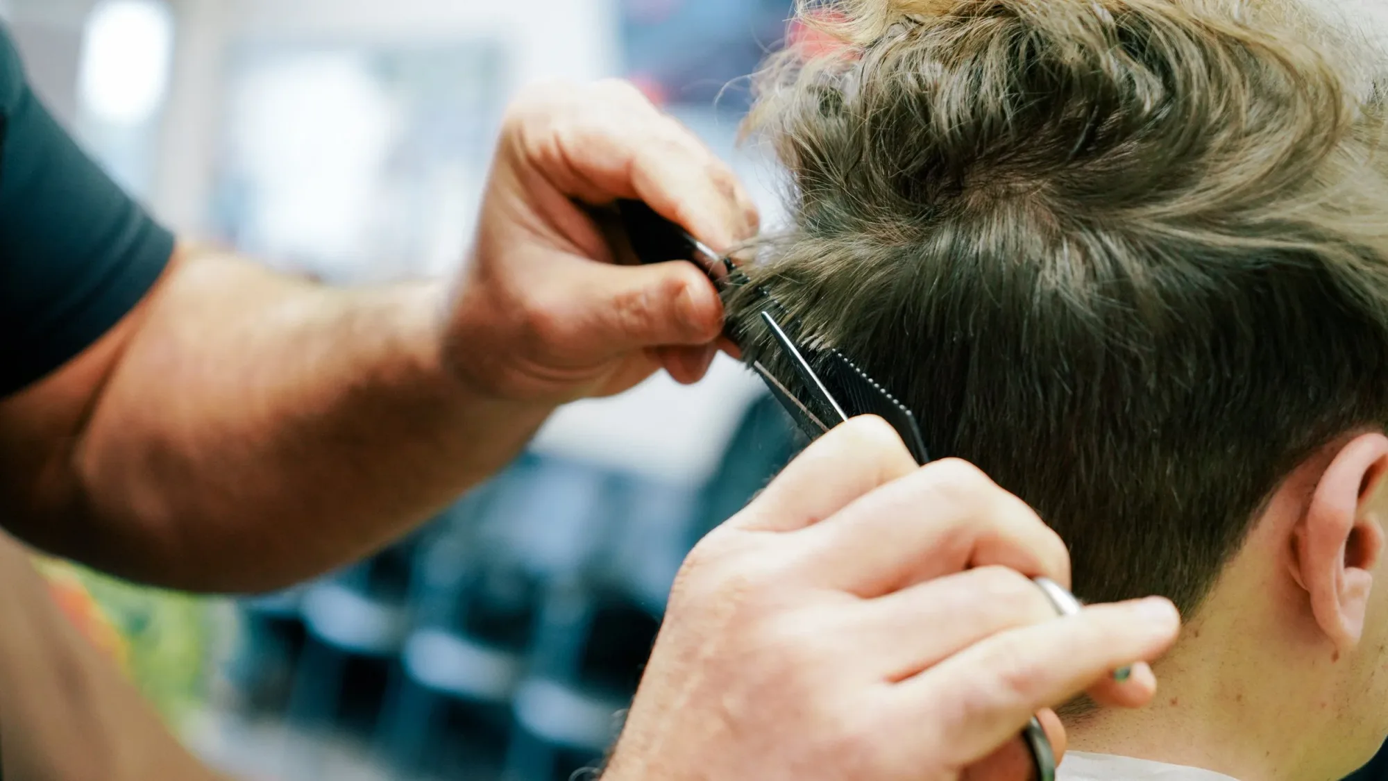 Scissor-over-comb work on the back of a men's haircut at Ledgewood Barber Shop